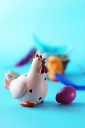 Easter toy chicken, eggs and feathers on bright background, congratulations concept, postcardの写真素材