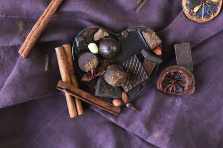 Chocolate, sweets and spices on linen fabric, top view, home cooking, sweet food