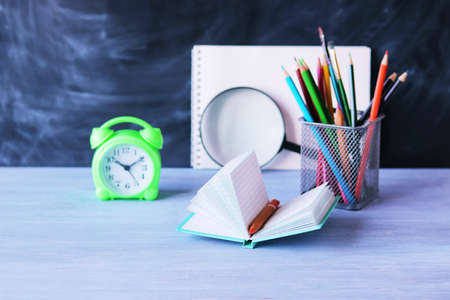 Open blank notepad, alarm clock, stationery on desk, education concept, back to school