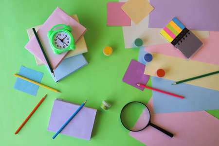 Books, alarm clock, stationery on the table, education concept, back to school