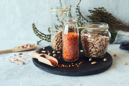Beans, chickpeas, lentils and dry herbs on the kitchen table, organic natural products for a healthy dietの写真素材