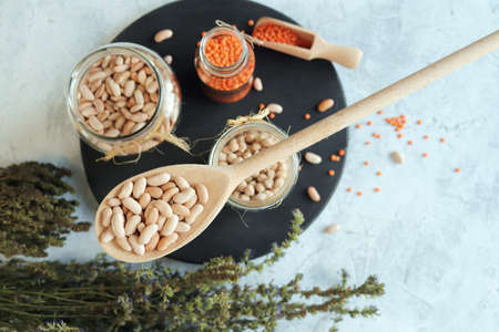 Beans, chickpeas, lentils and dry herbs on the kitchen table, organic natural products for a healthy dietの写真素材