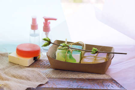 Handmade soap, spray, aromatic oil and healthy tinctures on a wooden table, the concept of...