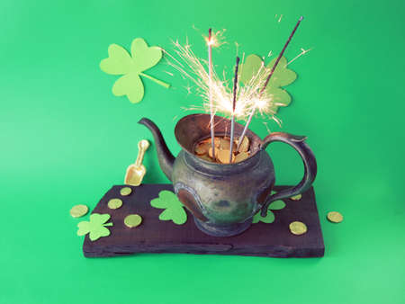 Patrick's Day, vintage pot with gold coins and burning sparklers, on a green background with...
