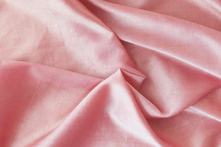 Pink fabric, natural silk lined with folds, top view, background for romantic congratulationsの写真素材