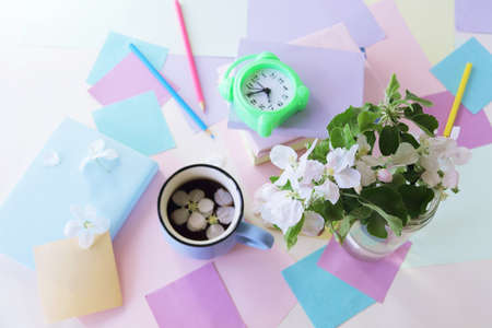 Back to school, alarm clock, apple tree flowers bouquet, stack of books, cup of tea, and stationery...