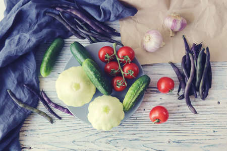 Fresh ripe variety of vegetables on a light kitchen table, organic products, healthy natural food,...