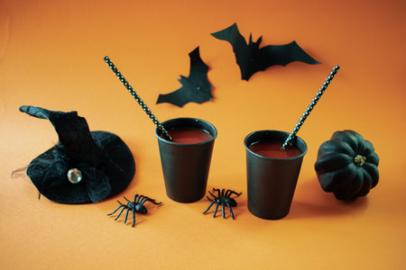 Halloween drinks. Halloween party concept. Black pumpkins on orange background.の写真素材