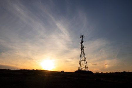 Silhouette of high voltage power line at sunset sky background.の写真素材