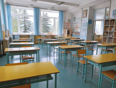 Interior of an empty school classroom with tables and chairs. Nobody insideの素材