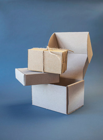 Cardboard boxes on a blue background. Copy space for text.