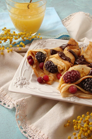 pancakes on kefir with berries and chocolateの写真素材