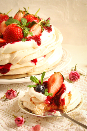 Cake "Pavlova" with fresh strawberries on white backgroundの写真素材