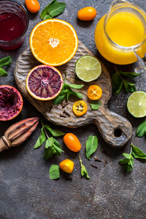 set of citrus fruits orange red, lemon, kumquat and citrus juice on wooden Boardの写真素材