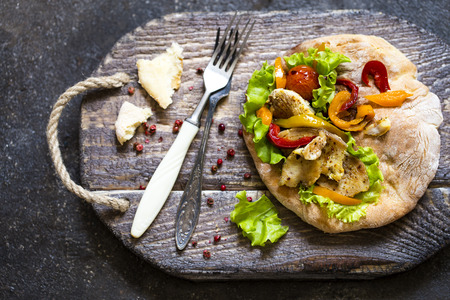 pita bread with vegetables and herbs in a rustic styleの写真素材
