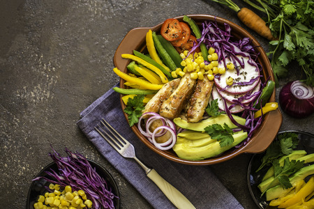 Grilled chicken, cabbage, pepper, avocado, tomato, greens, onion, buddha bowlの写真素材
