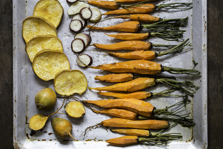 Grilled vegetables, carrots, turnips on light backgroundの写真素材