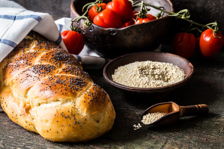 Challah is a Jewish bread to the feast on the dark wooden boards