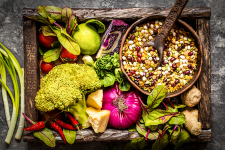 Fresh fruit, vegetables, cereals, nuts and greens, the ingredients for a healthy lifestyle, healthy food in a wooden boxの写真素材