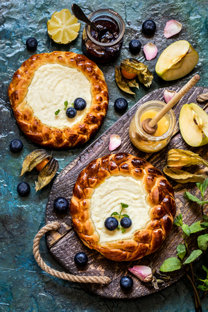 pie c fresh berries blueberries, fruit, with cottage cheese filling, cheesecake on a wooden Boardの写真素材