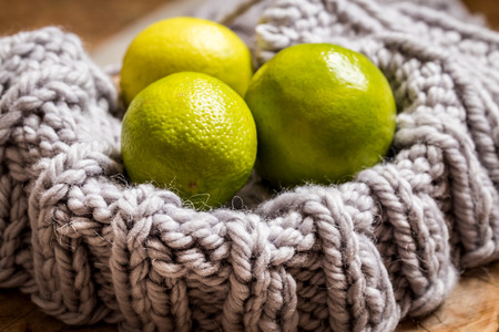 knitting gray wool, chunky knit with balls on wooden background