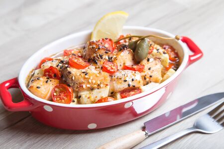 Salmon baked with sesame, tomatoes and zucchini. Close-up. Selective focus.の写真素材