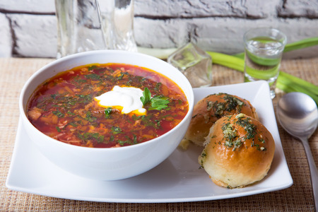Borscht/borsch. Traditional Russian and Ukrainian soup. Buns with garlic. Close-up, selective focus.の写真素材