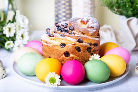 Craffin (Cruffin) with raisins and candied fruits. Easter Bread Kulich and painted eggs. Easter...