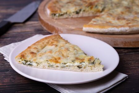 Ossetian pie with cheese and herbs (dill, parsley, scallion). Traditional Ossetian baking.の写真素材