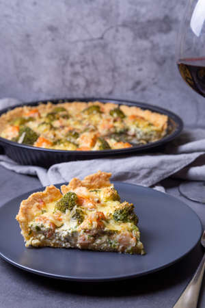 Quiche (open pie) with trout, broccoli and cheese. Homemade unsweetened pastries, traditional pie....