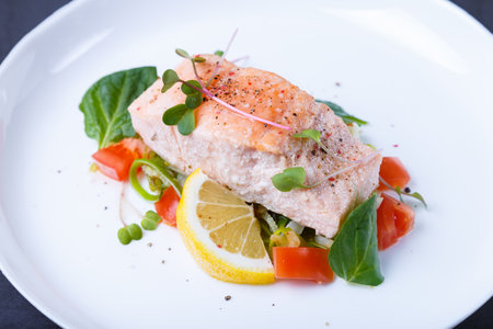 Trout (salmon) with vegetables, lemon and microgreens, cooked by the confit method. Traditional French dish. Step by step. Close-up.の写真素材