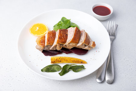 Files of the breast duck grill with beets, mini corn and spinach, fried sage, orange and lingonberry sauce. Traditional Mediterranean cuisine. Selective focus, close-up.の写真素材