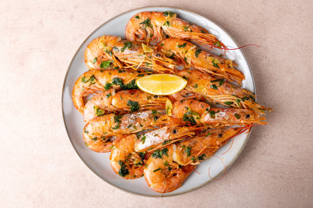 Langoustines fried in butter with garlic and parsley. Served with a slice of lemon. Traditional...