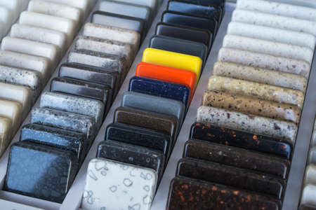 Layout: colorful specimens of granite, marble and quartz natural stone slabs.Close-up of stone kitchen countertops samplesの写真素材