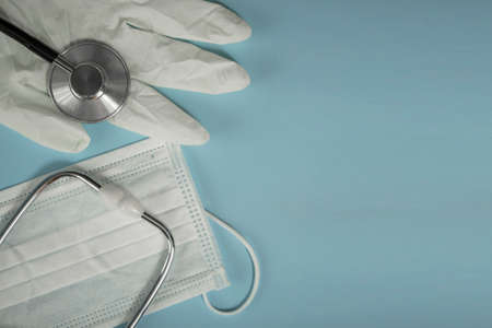 Medical plan, top view with place for text. on a blue background, mask, glove, stethoscope. Concept: family doctorの写真素材