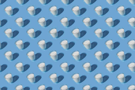 World Milk Day. Pattern on a blue background. A glass of milk. Pattern.の写真素材
