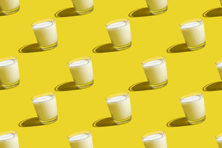World Milk Day. Pattern on a yellow background. A glass of milk. Sample.の写真素材