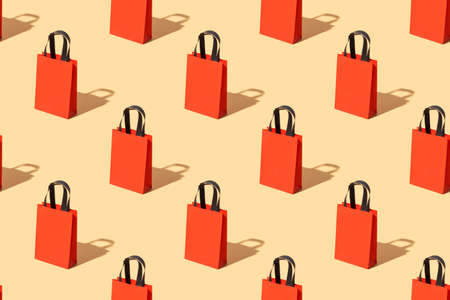 Bright red craft bag with black pattern handles on a beige background. Black friday concept. Big Saleの写真素材