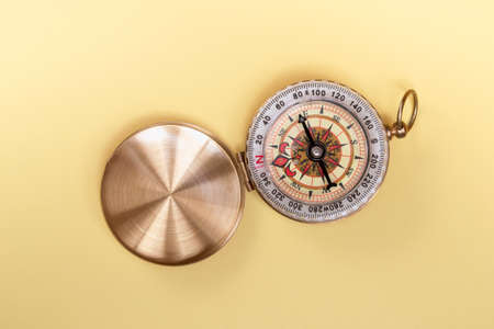compass on yellow background close up with copy spaceの写真素材