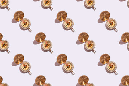 compass on white background close-up with hard shadows with copy space. Pattern on white backgroundの写真素材