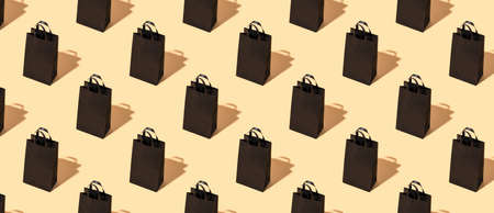 Pattern on a beige background black craft package. Black friday concept. Big Saleの写真素材