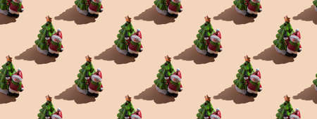 New Year's card close-up: a snowman with a Christmas tree on a beige background with a hard shadow. Top view, seamless pattern, bannerの写真素材