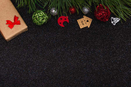Flat top view of New Year mockup on black shiny background with New Year elements and pine branch. Copy spaceの写真素材