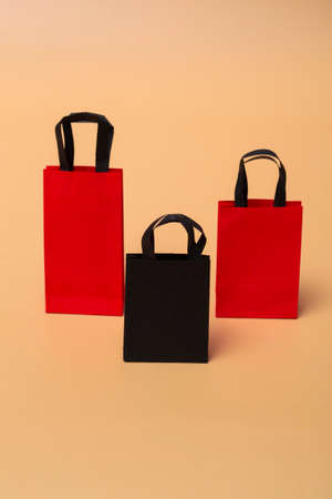 Black friday concept, mockup of paper black and red packages on colored background. Black Friday...