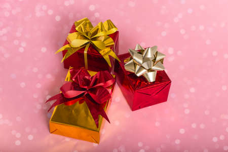 New Year Christmas composition. Gifts on a pink background with bokeh lights. Flat Top View Copy...