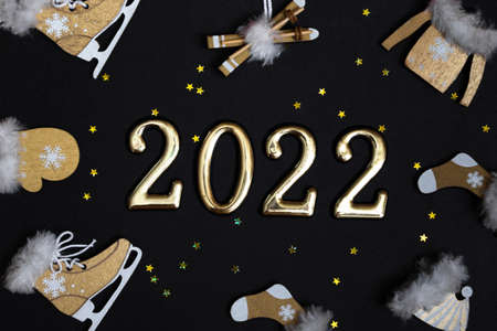 Top view flat New Year mockup on black background with numbers and New Year decor. New Year 2022, with copy spaceの写真素材