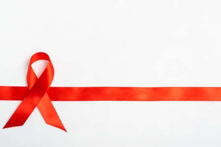Medical concept december world aids day. Red ribbon on a white background. Safe sex concept. Close...