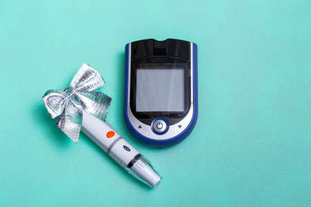 Christmas banner with holiday decorations and a glucometer for measuring blood sugar on a colored...