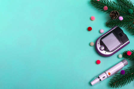 Christmas banner with holiday decorations and a glucometer for measuring blood sugar on a colored...