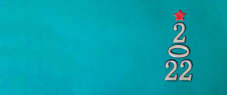 Holiday concept. Christmas background, golden numbers 2022 with red bow and star. Happy New Year. Bannerの写真素材